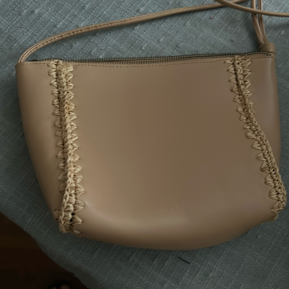 Small strap purse with zipper. Two separate sections inside. In great condition!